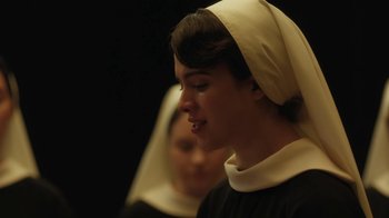Movie still from “Novitiate” (2017), directed by Maggie Betts – A woman in a nun's outfit is looking at the camera; Close Up shot, Over the shoulder angle