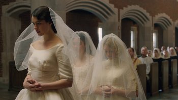 Movie still from “Novitiate” (2017), directed by Maggie Betts – Two women in wedding dresses standing next to each other; Medium shot, Over the shoulder angle