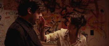 Movie still from “Obvious Child” (2014), directed by Gillian Robespierre – A man and a woman touching their faces; Medium shot, Over the shoulder angle