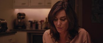 Movie still from “Obvious Child” (2014), directed by Gillian Robespierre – A person sitting in a room; Close Up shot, Over the shoulder angle