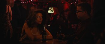 Movie still from “Obvious Child” (2014), directed by Gillian Robespierre – A woman sitting at a table with two beers in front of her; Medium shot, Over the shoulder angle