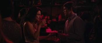 Movie still from “Obvious Child” (2014), directed by Gillian Robespierre – A man and a woman are holding drinks at a bar; Medium shot, Over the shoulder angle
