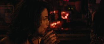 Movie still from “Obvious Child” (2014), directed by Gillian Robespierre – A woman is drinking a cup of coffee at night; Close Up shot, Over the shoulder angle