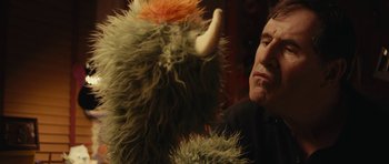 Movie still from “Obvious Child” (2014), directed by Gillian Robespierre – A man is looking at a stuffed animal; Close Up shot, Over the shoulder angle