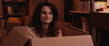 Movie still from “Obvious Child” (2014), directed by Gillian Robespierre – A woman sitting inside of a box in a room; Close Up shot, Over the shoulder angle