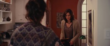 Movie still from “Obvious Child” (2014), directed by Gillian Robespierre – A woman in a sweater looking in the mirror; Medium shot, Over the shoulder angle