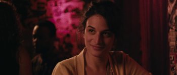 Movie still from “Obvious Child” (2014), directed by Gillian Robespierre – A person smiling for the camera; Close Up shot, Over the shoulder angle