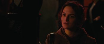Movie still from “Obvious Child” (2014), directed by Gillian Robespierre – A woman is standing in the dark holding a bag; Close Up shot, Over the shoulder angle