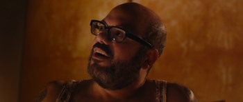 Movie still from “Obvious Child” (2014), directed by Gillian Robespierre – A man with a beard wearing glasses looking up; Close Up shot, Over the shoulder angle