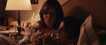 Movie still from “Obvious Child” (2014), directed by Gillian Robespierre – A woman sitting next to another woman on a bed; Medium shot, High angle