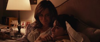 Movie still from “Obvious Child” (2014), directed by Gillian Robespierre – A woman sitting next to a boy in a bed; Close Up shot, Over the shoulder angle