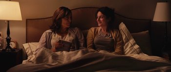 Movie still from “Obvious Child” (2014), directed by Gillian Robespierre – Two women sitting in a bed talking to each other; Medium shot, Over the shoulder angle