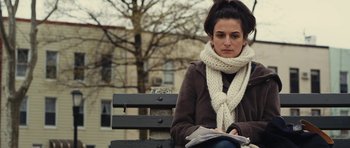 Movie still from “Obvious Child” (2014), directed by Gillian Robespierre – A woman sitting on top of a wooden park bench; Close Up shot, Low angle