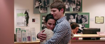 Movie still from “Obvious Child” (2014), directed by Gillian Robespierre – A man and a woman hugging each other in a room; Close Up shot, Over the shoulder angle