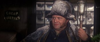 Movie still from “Oliver!” (1968), directed by Carol Reed – A man wearing a fur hat and a fur coat; Close Up shot, Over the shoulder angle