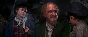 Movie still from “Oliver!” (1968), directed by Carol Reed – An old man with a beard and a long beard; Medium shot, Over the shoulder angle