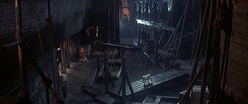 Movie still from “Oliver!” (1968), directed by Carol Reed – A dog walking in a room with a lot of furniture; Extreme Wide shot, High angle