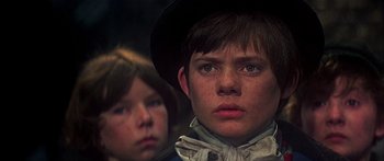 Movie still from “Oliver!” (1968), directed by Carol Reed – A boy and a girl wearing cowboy hats and bandannas; Close Up shot, Low angle