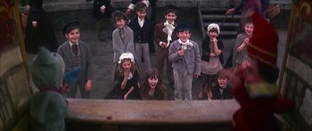 Movie still from “Oliver!” (1968), directed by Carol Reed – A group of children dressed in period clothing; Wide shot, High angle