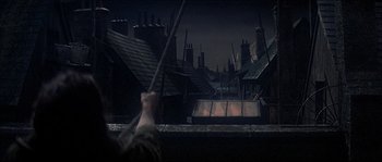 Movie still from “Oliver!” (1968), directed by Carol Reed – A view of a city at night from a window; Wide shot, High angle