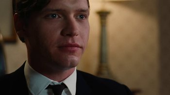 Movie still from “On Chesil Beach” (2017), directed by Dominic Cooke – A person wearing a suit and tie; Close Up shot, Over the shoulder angle
