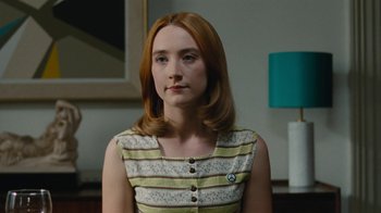 Movie still from “On Chesil Beach” (2017), directed by Dominic Cooke – A woman with red hair wearing a striped dress; Close Up shot, Over the shoulder angle