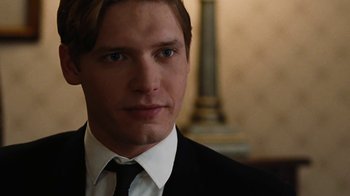 Movie still from “On Chesil Beach” (2017), directed by Dominic Cooke – A person wearing a suit and tie; Close Up shot, Over the shoulder angle