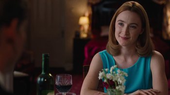 Movie still from “On Chesil Beach” (2017), directed by Dominic Cooke – A woman sitting at a table with a glass of red wine; Medium shot, Over the shoulder angle