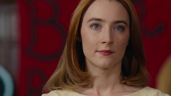 Movie still from “On Chesil Beach” (2017), directed by Dominic Cooke – A person with long hair and blue eyes; Close Up shot, Over the shoulder angle