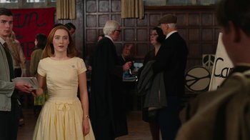 Movie still from “On Chesil Beach” (2017), directed by Dominic Cooke – A group of people standing in a room; Medium shot, Over the shoulder angle