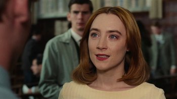 Movie still from “On Chesil Beach” (2017), directed by Dominic Cooke – A young woman with red hair standing in front of a man; Close Up shot, Over the shoulder angle