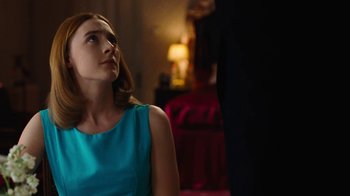 Movie still from “On Chesil Beach” (2017), directed by Dominic Cooke – A woman in a blue dress looking up at a man in a black suit; Medium shot, Over the shoulder angle