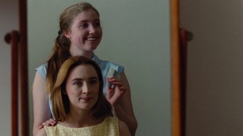 Movie still from “On Chesil Beach” (2017), directed by Dominic Cooke – Two young women posing for a picture in front of a mirror; Close Up shot, Over the shoulder angle
