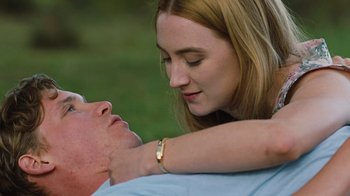 Movie still from “On Chesil Beach” (2017), directed by Dominic Cooke – A young woman is touching the face of an older man; Close Up shot, High angle