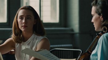 Movie still from “On Chesil Beach” (2017), directed by Dominic Cooke – A woman sitting at a table with a sheet of paper; Close Up shot, Over the shoulder angle