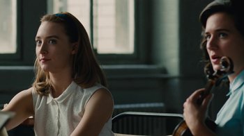 Movie still from “On Chesil Beach” (2017), directed by Dominic Cooke – A woman sitting next to another woman in front of a window; Close Up shot, Over the shoulder angle