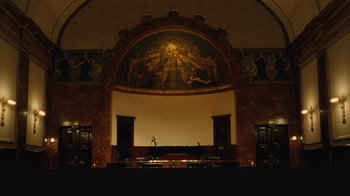Movie still from “On Chesil Beach” (2017), directed by Dominic Cooke – A church with a large painting on the side of the wall; Extreme Wide shot, Low angle