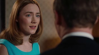 Movie still from “On Chesil Beach” (2017), directed by Dominic Cooke – A woman in a blue dress talking to a man in a black suit; Close Up shot, Over the shoulder angle