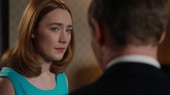 Movie still from “On Chesil Beach” (2017), directed by Dominic Cooke – A woman in a blue dress looking at a man in a black suit; Close Up shot, Over the shoulder angle