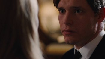 Movie still from “On Chesil Beach” (2017), directed by Dominic Cooke – A person wearing a suit and tie; Close Up shot, Over the shoulder angle
