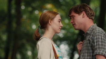 Movie still from “On Chesil Beach” (2017), directed by Dominic Cooke – A man and a woman standing next to each other in front of a tree; Close Up shot, Over the shoulder angle