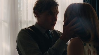 Movie still from “On Chesil Beach” (2017), directed by Dominic Cooke – A man touching a woman's face with his hand; Close Up shot, Over the shoulder angle
