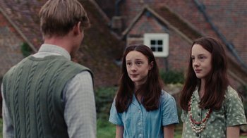 Movie still from “On Chesil Beach” (2017), directed by Dominic Cooke – A group of young people standing next to each other; Medium shot, Over the shoulder angle