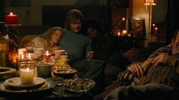 Movie still from “On Chesil Beach” (2017), directed by Dominic Cooke – A group of people sitting around a table with candles; Medium shot, High angle