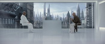 Movie still from “Mr. Nobody” (2009), directed by Jaco Van Dormael – Two people sitting in front of a large window with a view of a city; Wide shot, High angle