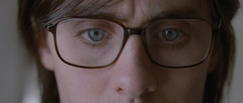 Movie still from “Mr. Nobody” (2009), directed by Jaco Van Dormael – A person wearing glasses; Extreme Close Up shot, Overhead angle