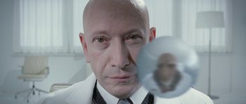 Movie still from “Mr. Nobody” (2009), directed by Jaco Van Dormael – A bald man in a white lab coat looking into a mirror; Extreme Close Up shot, Low angle