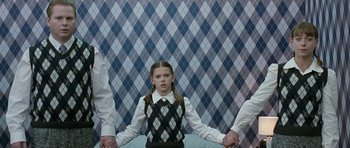Movie still from “Mr. Nobody” (2009), directed by Jaco Van Dormael – A young girl is standing between two adults; Medium shot, Low angle