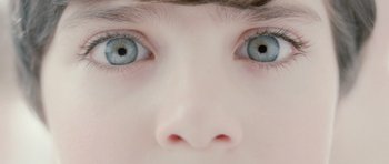 Movie still from “Mr. Nobody” (2009), directed by Jaco Van Dormael – A child's face with blue eyes; Extreme Close Up shot, Overhead angle