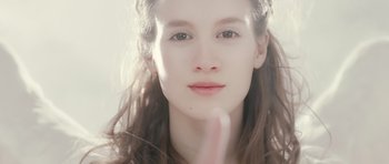 Movie still from “Mr. Nobody” (2009), directed by Jaco Van Dormael – A young woman's face with her fingers crossed; Close Up shot, Low angle